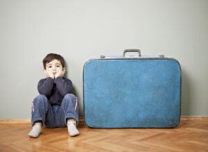 Child Near Suitcase Ready to Move