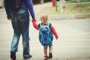 Child Walking to School With Father