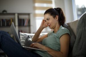 Woman On Laptop Thinking of Divorce Options