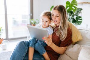Mom and daughter Viewing Parenting Plan On Online Ap.